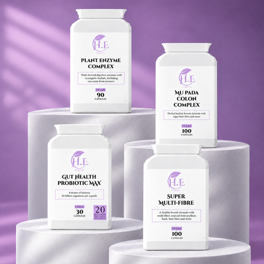 Four white supplement bottles from the brand H.E arranged on white cylindrical pedestals against a purple studio background.