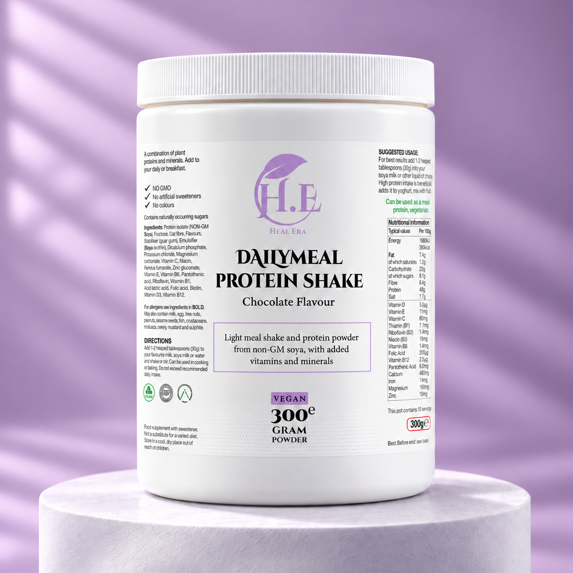 A white plastic tub of H.E Plant Based Dairymeal Protein Shake in Chocolate Flavour, displayed on a white cylindrical pedestal against a purple background with soft diagonal light streaks.