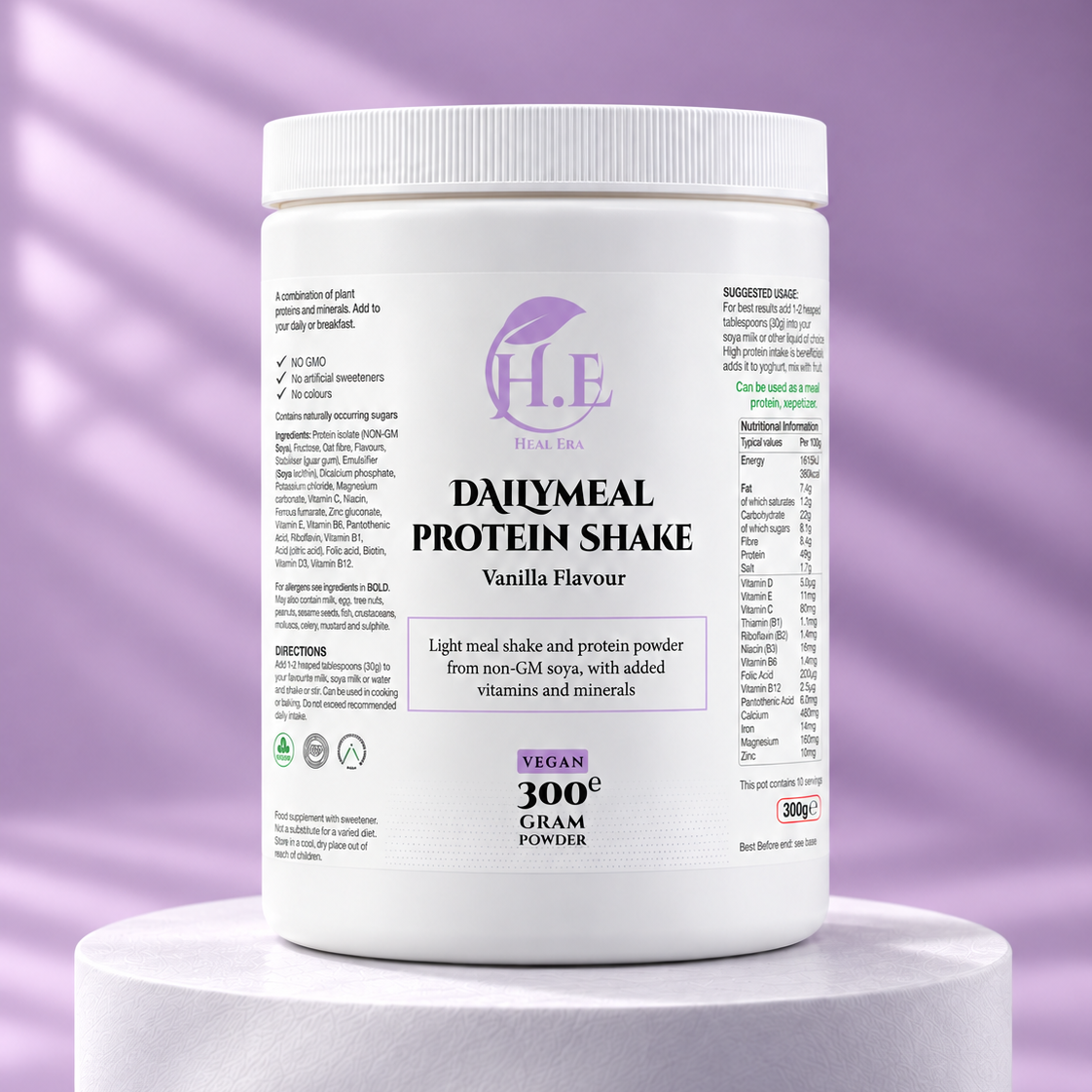A white plastic tub of H.E Vegan Protein Powder in Vanilla Flavour, displayed on a white cylindrical pedestal against a purple background with soft diagonal shadows.