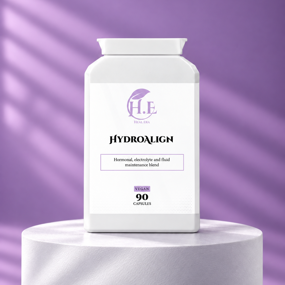 A white bottle of H.E Body Tea HydroAlign vegan capsules, displayed on a white cylindrical pedestal against a purple background with soft diagonal shadows.