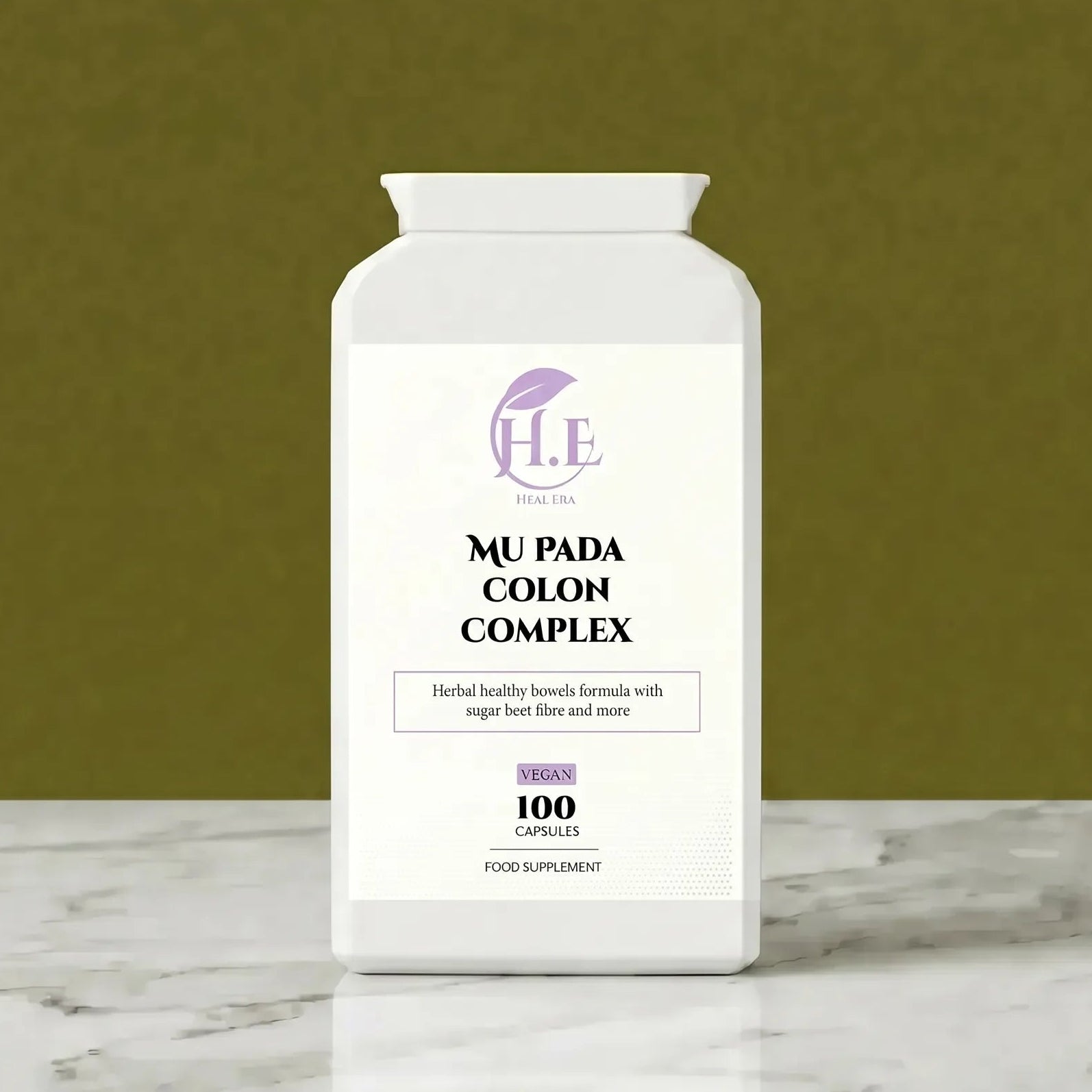 A white bottle of H.E Wellness Center Mu Pada Colon Complex dietary supplement, set on a white marble surface against a textured olive green background.