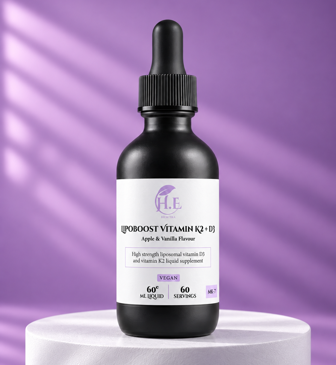 A black glass dropper bottle of H.E [IPOOOST VITAMIN K2 + E] liquid supplement, displayed on a white pedestal against a purple background with soft diagonal shadows.