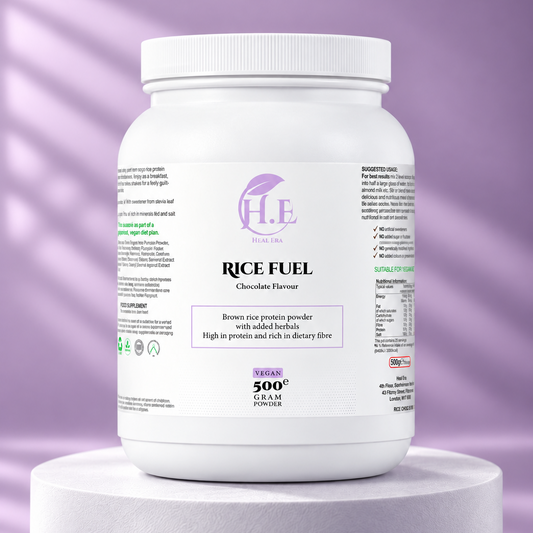 A white plastic tub of H.E Nutrition Rice Fuel Chocolate Flavour powder sits on a white cylindrical pedestal against a lavender-purple background with soft diagonal shadows.